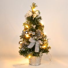 a small christmas tree decorated with lights and ornaments