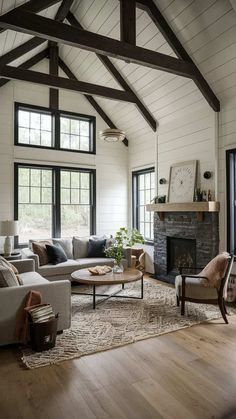 a living room filled with furniture and a fire place in the middle of a room