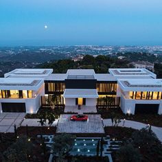 an aerial view of a modern house at dusk