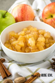 apples and cinnamon in a white bowl next to an apple