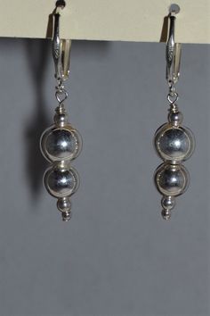 Custom designed and hand crafted by Dodie Stewart.  Stunning pair of earrings fashioned from hand-wired 5mm sterling silver globes.  The latch back clasp is sterling silver.  Length: 1½ inches.  Inv. No. 2731/03 Classic Nickel-free Round Bead Earrings, Classic Nickel-free Earrings With Round Beads, Elegant Sterling Silver Hoop Earrings With Round Beads, Sterling Silver Sphere Earrings, Adjustable Sterling Silver Clip-on Earrings, Handmade Classic Silver Clip-on Earrings, Handmade Silver Clip-on Classic Earrings, Classic Silver Jewelry With Lever Back Ear Wires, Silver Handmade Classic Clip-on Earrings