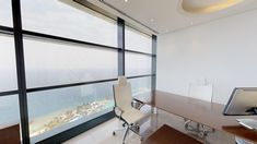 an office with a large window overlooking the ocean