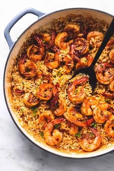 a skillet filled with rice and shrimp