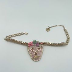 This Is A New Without Tags Betsey Johnson Statement Necklace!! This Necklace Has Never Been Worn But No Longer Has The Tags. Gold Tone Plating Skull With Pink Face And Roses In Background. Multi Colored Metal Flowers Across Forehead Of The Skull. Skull Has Heart Shaped Eyes And Nose With Pink Glitter. Gold Plated Chain Has Iridescent Stones Woven Through It On Pink Fabric. Metal/ Glass/ Plastic Lobster Clasp Closure Approx. 16" Length With 3" Extender; 3" X 0.3" Pendant Drop Bundle Any Two Items Pink Metal Choker For Party, Pink Chain Jewelry For Festival, Adjustable Pink Metal Choker, Skull Pendant Necklace, Betsey Johnson Jewelry, Floral Skull, Skull Pendant, Metal Flowers, Pink Fabric