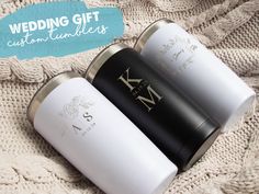 two white and black wedding gifts sitting on top of a blanket with the words, wedding gift custom tumblers