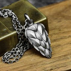 Material: 925 silver, brass Size: 19mm*46mm (thick) Weight: Brass: about 23g                  Silver: about 27g ◆This is a handmade dragon scale urn pendant. Each item is custom made and has a special meaning to you. How special your loved ones are to you and how sad it is when they leave us. This necklace includes a hollow urn pendant to hold the cremated ashes of your loved one for long-lasting remembrance and companionship. ◆Unscrew the screw cap of the round ring at the top, fill it with ash Silver Carved Brass Jewelry, Carved Silver Brass Jewelry, Medieval Style Engraved Antique Silver Jewelry, Medieval Silver Brass Jewelry, Urn Pendant, Urn Jewelry, Women Pendant, Urn Necklaces, Dragon Scale