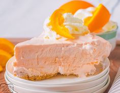 a slice of cheesecake with whipped cream and oranges