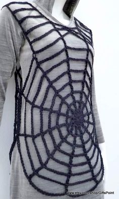 a woman's sweater with a spider web on it