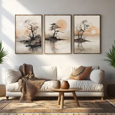 a living room with three paintings on the wall