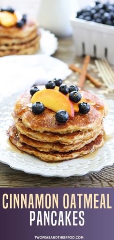 a stack of pancakes with blueberries and peaches on top