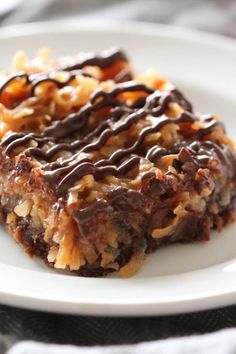 some kind of dessert on a white plate with chocolate drizzled over it