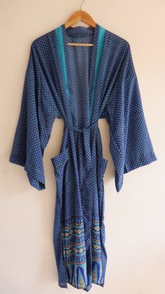 "Silk Polyester kimono robes are perfect for lounging around the home or spa. Use our silk robe as a cover up on the beach or after a dip in the pool. Add a luxe, boho feel to your bridal shower. Versatile, soft and luxurious, our silk kimono robes are printed with azo-free dyes. The silk Polyester robe features full sleeves, a waist tie and two front pocket. Length - 50 inches (125Centimeter), Measurements Approx : *Length: 50\" Inches *Bust Around Size: 50\" Inches *Shoulder: 8\" Inches *Sleev Bohemian Wrap Robe For The Beach, Blue Summer Robe For Relaxation, Bohemian Wrap Robe For Beach, Bohemian Wrap Beach Robe, Blue Beachwear Cover-up For Loungewear, Blue Beachwear Sleepwear For Vacation, Blue V-neck Cover-up For Loungewear, Summer Home Sleepwear With Kimono Sleeves, Summer Sleepwear With Kimono Sleeves For Home