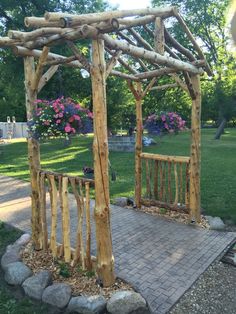 a wooden gazebo sitting on top of a brick walkway