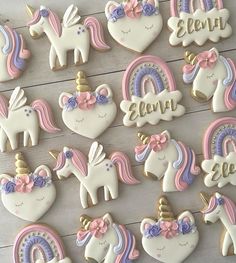 decorated cookies with unicorns and rainbows are arranged on a table