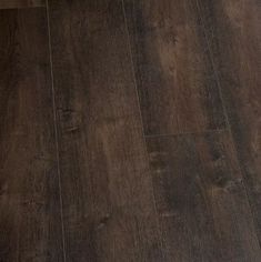 an image of a wood floor that looks like it has been painted in dark brown