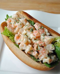 there is a sandwich with shrimp and lettuce on it