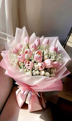 a bouquet of pink tulips and white baby's breath