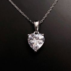 Solid Sterling Silver Clear Topaz necklace. Diamond is the April birthstone, get the look for April with this beautiful birthstone heart pendant in clear Topaz.  Matching earrings available here: https://www.etsy.com/listing/1338805708/  Available to order in gold, white gold, rose gold or platinum, please contact me for prices.  💎Pendant thickness: 6mm 💎Pendant width: 9mm 💎Pendant overall Length: 17mm 💎Chain length: 18 inch or other length if required.  ✨ For free giveaways, special offers Classic Heart Cut Birthstone Necklace, Heart Cut Cubic Zirconia Birthstone Necklace, Classic Heart-shaped Birthstone Necklace, Crystal Heart Charm Necklace For Anniversary, Anniversary Crystal Jewelry With Heart Charm, Crystal Heart Pendant Necklace Gift, Crystal Heart Pendant Necklace For Gift, Mother's Day Heart Cut Crystal Heart Necklace, Classic Heart Shaped Birthstone Jewelry