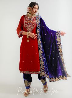 This indigo color velvet shawl with red color shirt and indigo color salwar set with intricate marodi and resham embroidery work is a must-have for anyone who wants to make a bold fashion statement. The high-quality fabric and detailed embroidery work make it a timeless and elegant outfit that will leave a lasting impression. The red color of the shirt complements the indigo color of the shawl and salwar perfectly. The shirt also features embroidery work on the neckline and cuffs, which adds a s Marodi Embroidery, Resham Embroidery, Designer Anarkali Suits, Curated Outfit, Velvet Shawl, Indigo Color, Add Sleeves, Saree Gown, Indian Wedding Wear