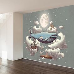 an empty room with a mural of a whale floating in the sky and ships below