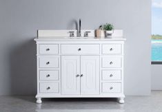 a white bathroom vanity with two sinks and mirrors on the wall next to a window