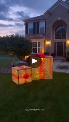 a house that has lights on it in front of the grass and bushes, with a video screen showing how to set up an outdoor lighting box