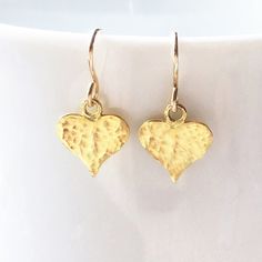 These perfectly stunning, rich gold vermeil hearts are hammered to reflect the light, and then hung on snug i.e.  'close fitting' 14kt gold fill hooks.   Vermeil is 18kt gold over sterling silver - all solid previous metals.   Hammered on front only. Delicate, modern drop earrings to wear everyday, or to gift to someone special as a perfect little 'thank you'.   Handmade jewelry at its best. You can choose Sterling silver or rose gold vermeil in the menu * Length: overall 2cm (3/4 inch)  * Verme Gold Heart Earrings, Romantic Earrings, Gold Heart Earring, Dangle Earrings Gold, Romantic Jewelry, Mum Birthday Gift, Romantic Jewellery, Hammered Gold, Uk Gifts