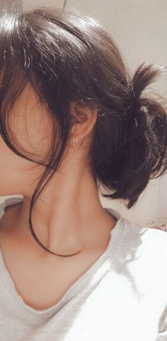 the back of a woman's head, with her hair in a pony tail