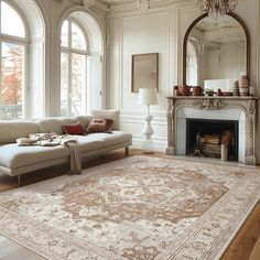 a living room filled with furniture and a large rug on top of a hard wood floor