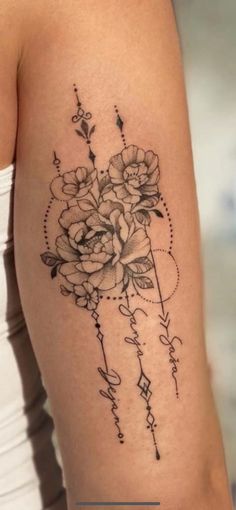 a woman's arm with flowers on it and the word love written in cursive