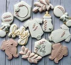 decorated baby cookies are arranged on a table