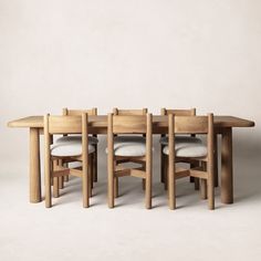 a group of wooden chairs sitting around a table