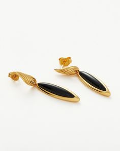 Wavy Ridge Gemstone Double Drop Earrings 18ct Gold Plated/Black Onyx. These Double Drop Earrings Feature Black Onyx Gemstones — Known for Protection — and Twisted Ridge Detailing in their Sculptural Design. Let this Delicate Pair Dangle Solo or Style with Mini Hoops and Studs for an Instant Ear Stack. Metal: 18Ct Recycled Gold Plated on Brass Width: 5mm - 7. 7mm Length: 41. 1mm Gemstone: Black Onyx Weight: 5. 6g Product Code: Wr-G-E6-Bx Luxury Black Earrings With Polished Finish, Black Polished Earrings For Evening, Black Polished Finish Earrings For Evening, Black Polished Evening Earrings, Black Polished Finish Fine Jewelry Earrings, Luxury Onyx Drop Earrings, 14k Gold Polished Finish Earrings For Evening, Formal Yellow Gold Earrings With Black Enamel, Yellow Gold Drop Earrings With Black Enamel