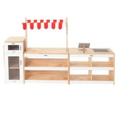 a toy kitchen with red cups on the counter