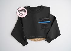 Puff Thin Blue Line Sweatshirt, Custom Embossed Police Sweatshirt, Thin Blue Line Sweatshirt, Police Gift for Police mom, Police wife This soft t-shirt or sweatshirt can be custom printed with a name and/or badge number. The print is embossed puff print. See color options in the photos. The shirt pictured above is black with black embossed puff print. ITEM DETAILS * T-Shirt, depending on color, either 100% preshrunk cotton, OR 50% cotton, 50% polyester * Unisex Sizing: XS, S, M, L, XL, 2XL * Cre Police Shirts Law Enforcement, Police Mom Shirt, Back The Blue Shirt, Police Wife Shirt, Police Mom, Police Shirts, Police Gifts, Police Officer Gifts, Police Wife