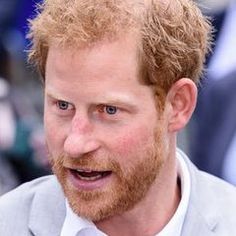 a close up of a person wearing a suit and tie