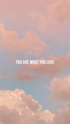 the words you are what you love written in white on a pink and blue sky