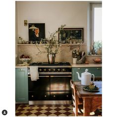 a kitchen with an old fashioned stove and green cabinets