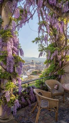 wister covered patio with table and chairs overlooking cityscape in the back ground