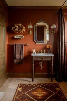 a bathroom with a sink, mirror and rug