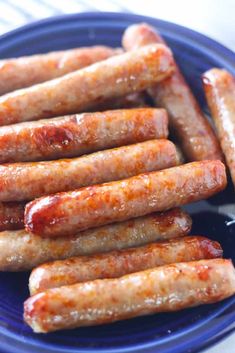 several sausages on a blue plate ready to be eaten