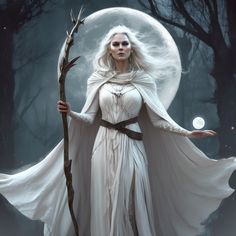 a woman dressed as a white witch holding a staff in front of a full moon