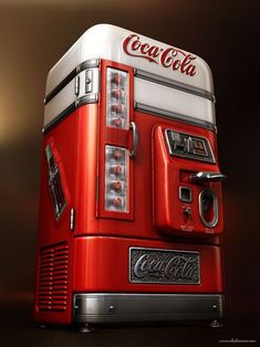 a red and white coca cola machine sitting on top of a table