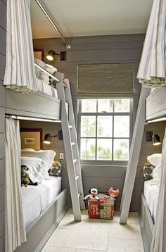 two bunk beds with ladders in a small room