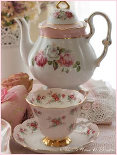 a tea set with pink roses on it