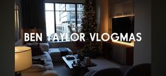 a living room filled with furniture and a christmas tree next to a large window that reads ben taylor vologmas