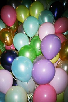 a bunch of balloons that are in the air