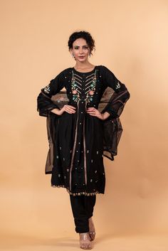 Stunning embroidery and print details adorn this round-neck Kurti set. The set includes a Kurti, pants, and dupatta, and features 3/4 length sleeves. Three beautiful components, one flawless ensemble. Navratri Anarkali Set With Floral Embroidery, Floral Embroidered Anarkali Set For Eid, Anarkali Palazzo Set With Floral Embroidery For Festivals, Festive Black Floral Embroidered Palazzo Set, Anarkali Style Black Palazzo Set With Floral Embroidery, Black Anarkali Palazzo Set With Floral Embroidery, Festive Black Palazzo Set With Floral Embroidery, Anarkali Sets With Floral Embroidery For Festive Season, Navratri Chanderi Sets With Resham Embroidery