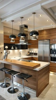 a modern kitchen with an island and stools