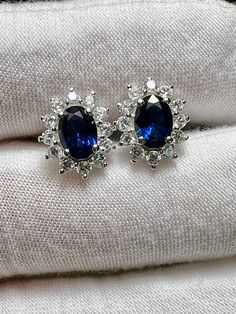 Natural Blue Sapphire & White Sapphire Halo 925 Sterling Silver Stud Earrings  natural oval blue sapphires (7.1mm x 5mm) natural white sapphire halos Total Measurement including halo: 11.5mm x 9.3mm Blue Bridal Earrings, Sapphire Earring, Blue Sapphire Earrings, Blue Sapphire Studs, Sapphire Stud Earrings, Halo Stud Earrings, Sapphire Earrings Studs, Sapphire Studs, Halo Earrings Studs